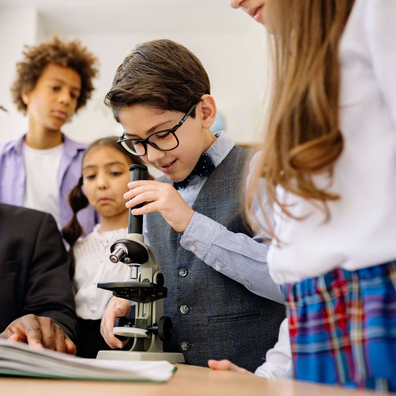 Children in a classroom exploring with a microscope